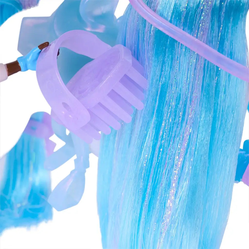 Unicorn Academy playset close-up showing translucent lavender plastic hair comb against glittery blue synthetic unicorn mane, highlighting texture, molded details, and accessory function for grooming and styling play.
