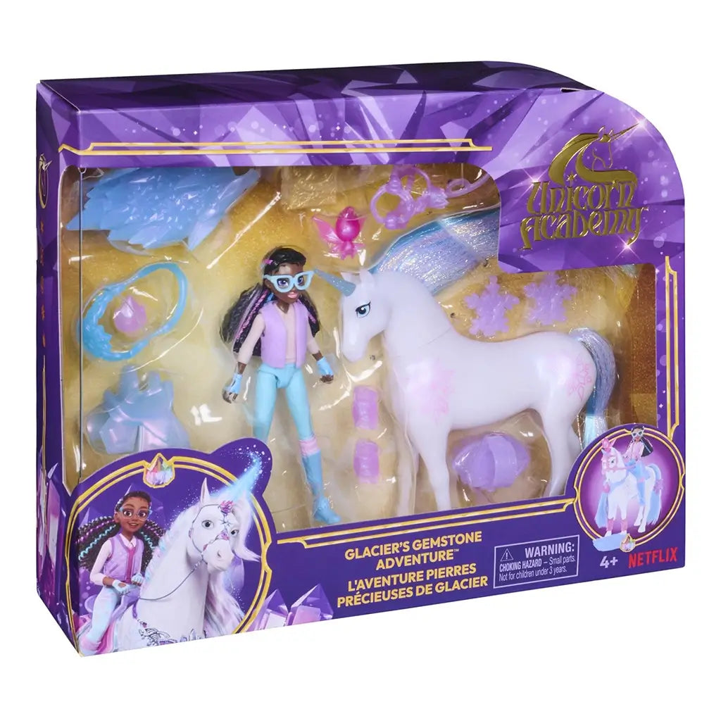 Unicorn Academy Gem Hunt playset front package view with purple and gold printed box, clear molded window, pastel unicorn figure, Layla character doll, and themed accessories presented for retail display.