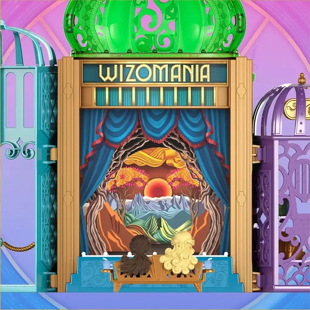 Wicked Emerald City Wizomania theater detail featuring gold and green plastic stage with illustrated backdrop, ornate framing, and seating area designed for dramatic storytelling scenes inspired by Universal Pictures Wicked.