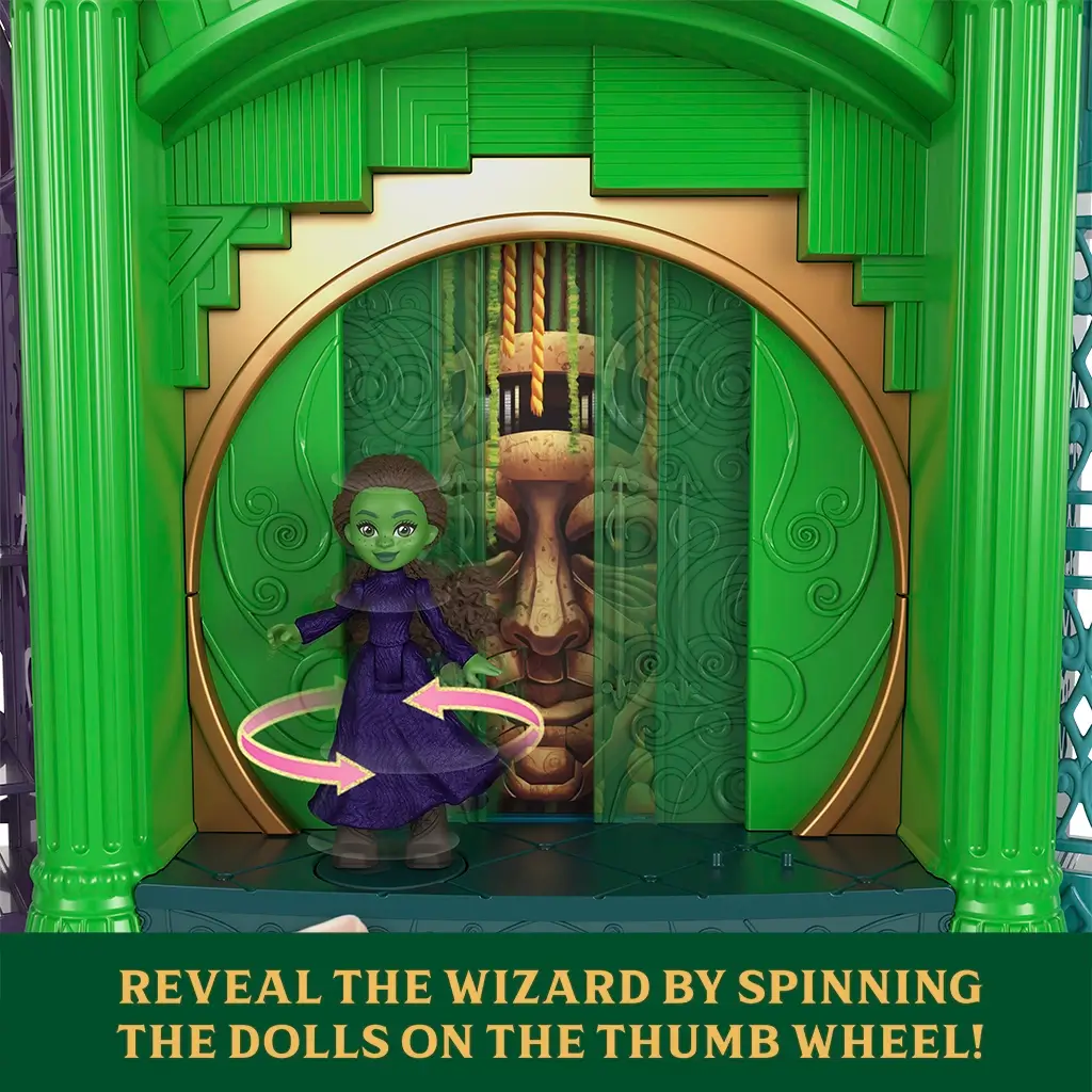 Wicked Emerald City interactive feature showing green plastic archway with hidden wizard reveal, demonstrating thumb wheel mechanism that spins dolls to unveil character imagery inspired by the Wizard of Oz setting.