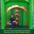 Wicked Emerald City interactive feature showing green plastic archway with hidden wizard reveal, demonstrating thumb wheel mechanism that spins dolls to unveil character imagery inspired by the Wizard of Oz setting.