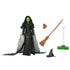 Wicked Elphaba doll accessories displayed separately in brown, black, and clear plastic materials, including broom, spell book, pointed hat, and display stand, all molded with textured details to support posing, storytelling, and shelf presentation.