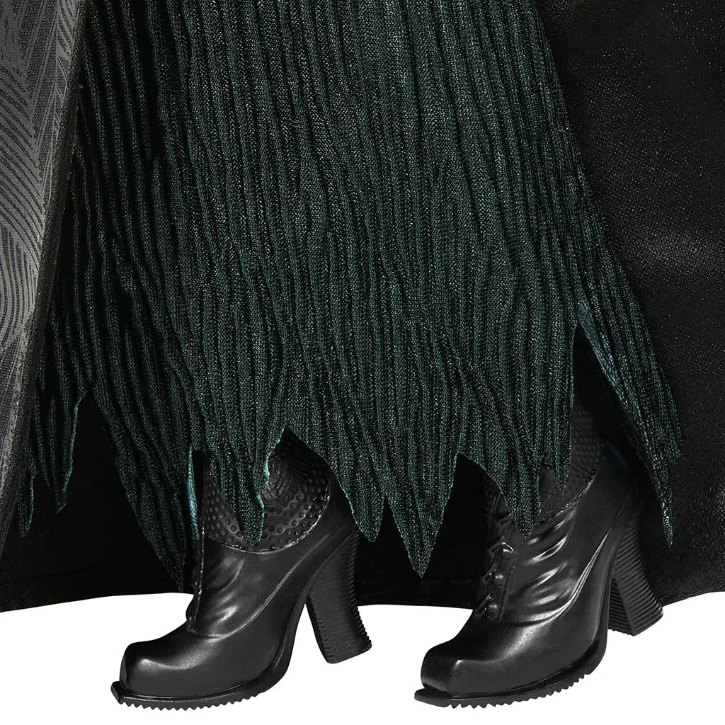 Wicked Elphaba Thropp doll shoe detail shows glossy black heeled boots with molded seams and sturdy soles, paired with dark green textured skirt fabric, illustrating durable construction and character-accurate footwear design.