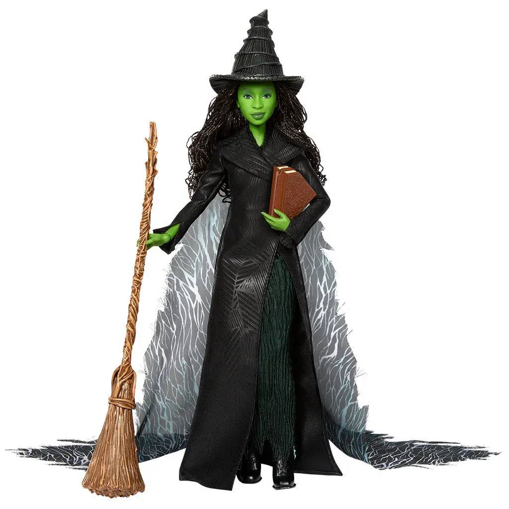 Wicked Elphaba Thropp deluxe fashion doll shown in deep black and emerald green colors, with textured fabric coat, flowing layered skirt, pointed witch hat, and broom accessory, portraying the iconic Wicked character for imaginative play or display.