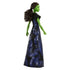 Wicked Elphaba doll side view showing green skin, long dark hair pulled back, flowing black and blue patterned gown, emphasizing silhouette and costume shape against a white studio background.
