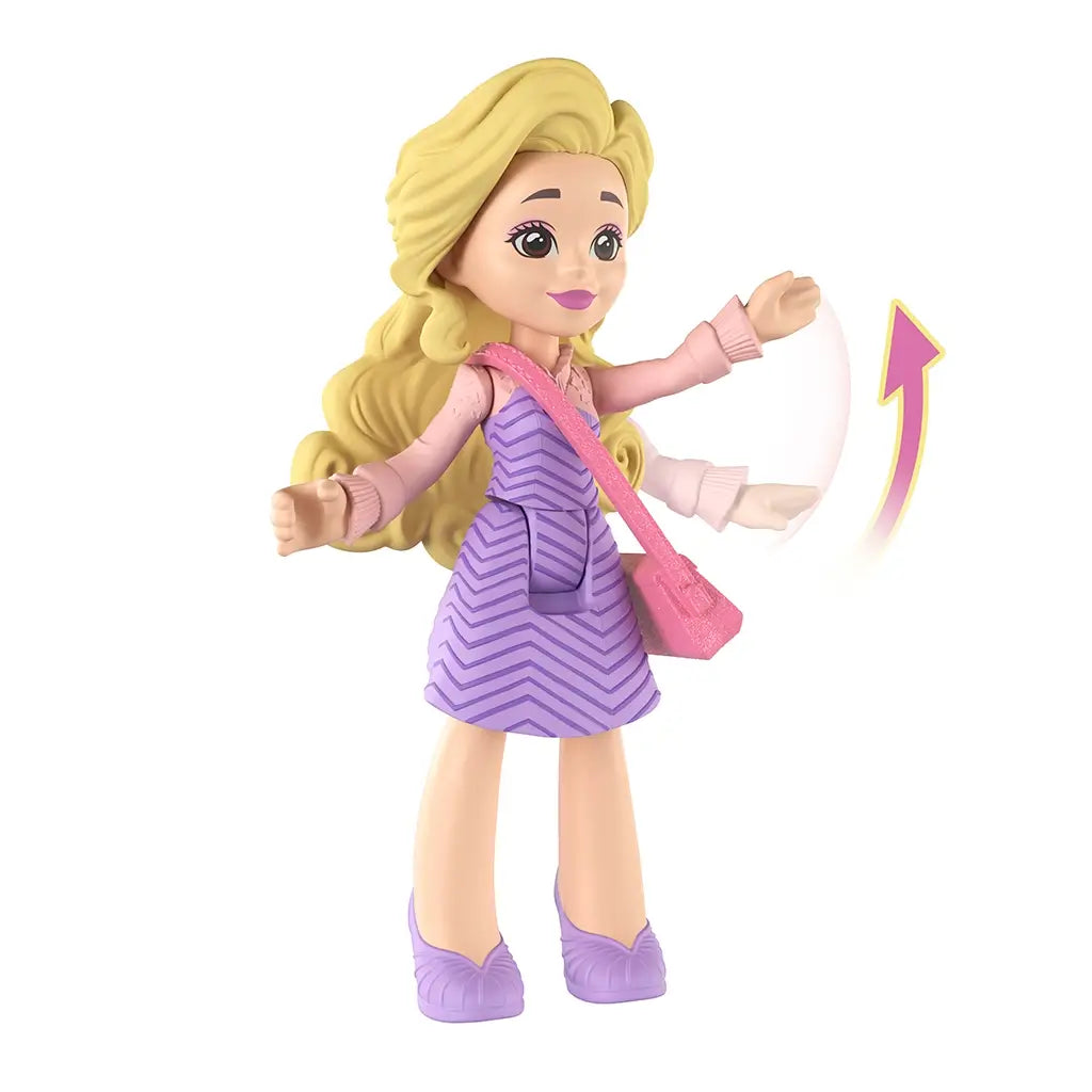 Universal Pictures Wicked doll shows a lavender and pink plastic Glinda mini figure with wavy blonde hair, patterned dress, purse accessory, and articulated arms posed waving against a clean white studio background.