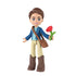 Universal Pictures Wicked doll depicts a blue and tan plastic Fiyero mini figure with brown molded hair, jacket outfit, boots, crossbody satchel, and red flower accessory, standing upright on a white studio background.