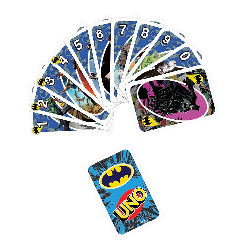Spread of Batman UNO cards with blue bat-logo patterned background, showing characters like Batman, Robin, villains, and a central UNO card with Batman emblem.