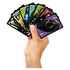 Hand holding Beetlejuice UNO playing cards, showing characters in bright costumes with green, red, purple, and black backgrounds, emphasizing the spooky theme and bold artwork.