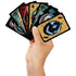 A hand holds several colorful UNO Wednesday playing cards with black borders, featuring character portraits, numbers, and special action symbols from the Netflix series.