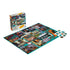 Seinfeld jigsaw puzzle glossy cardboard surface featuring vibrant collage of show scenes and characters, partially assembled rectangular puzzle with loose pieces beside branded box on clean white background.
