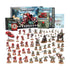Warhammer 40,000 Armageddon launch box set featuring red painted Blood Angels, green Ork miniatures, plastic vehicles, rulebooks, cards and decals arranged on a clean white background.