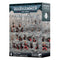 Warhammer 40,000 Adepta Sororitas Combat Patrol box shows gray and black matte cardboard packaging, rectangular in form, presenting Citadel miniatures for tabletop wargaming, arranged on rocky ground within a gothic city ruin battlefield.