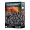 Warhammer 40,000 Combat Patrol Raven Guard miniature box with 17 dark-armored warriors and a dreadnought mech advancing across war-torn ruins under an orange sky.