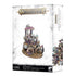 Warhammer Age of Sigmar miniature featuring pale flesh tones with rich purple and gold armor, an ornate grotesque lord seated on a lavish palanquin, representing Glutos Orscollion, Lord of Gluttony, displayed on a distressed white retail box background.