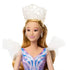 Wicked Glinda fashion doll close-up shows light pink skin tone, smooth vinyl face, long blonde hair, and a translucent white crown, highlighting delicate makeup details and a regal fantasy character inspired by the Wicked musical.