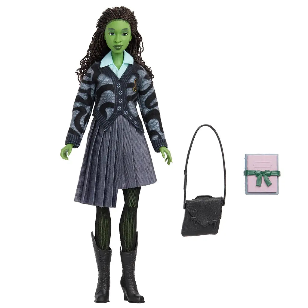 Full Wicked Elphaba fashion doll wearing school uniform with gray pleated skirt, black boots, and accessories including black shoulder bag and pink book.