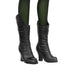 Close-up of Wicked Elphaba doll's black lace-up boots with pointed toes, textured leather-like finish, and green fishnet tights underneath.