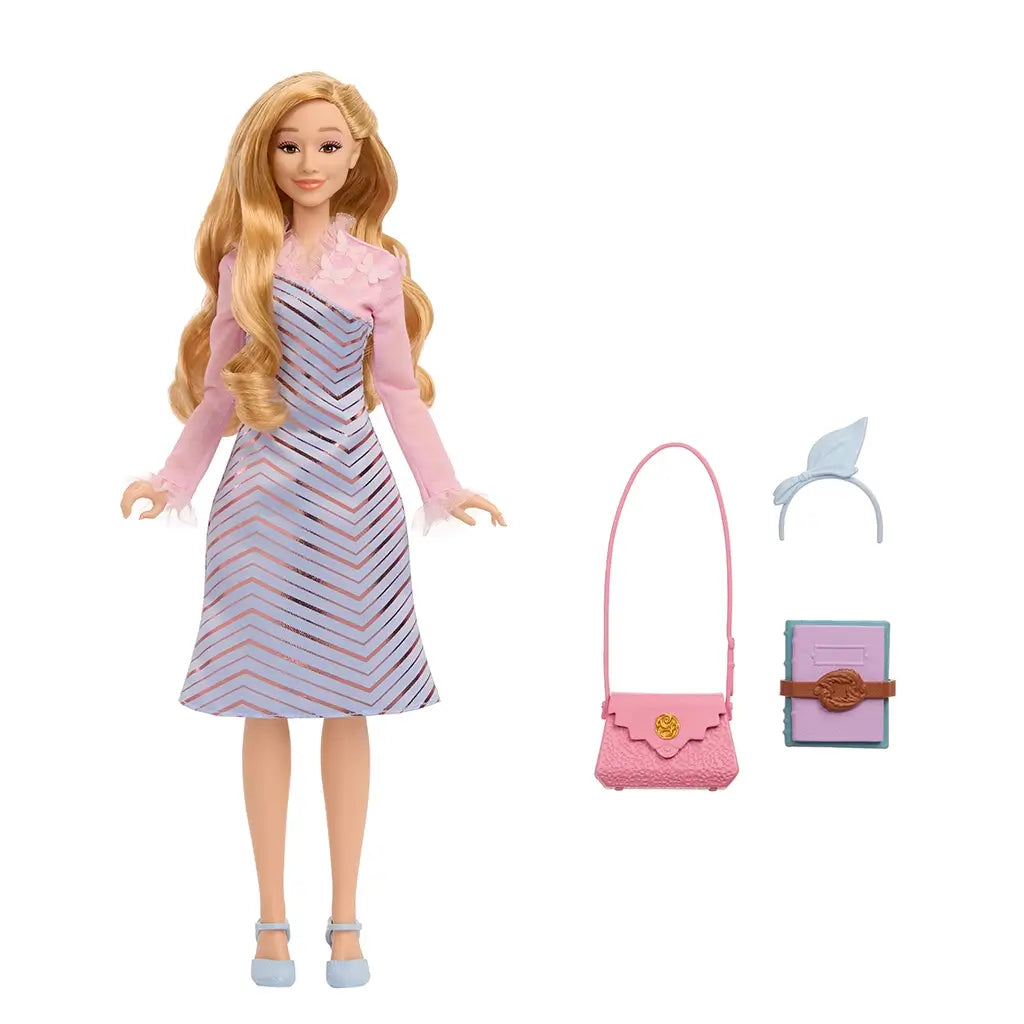 Wicked Glinda doll with accessories including light blue headband bow, textured pink purse with gold clasp, and pastel book with brown strap.