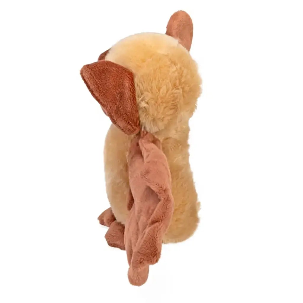 Wild Republic bat plush hugger displaying brown and tan soft polyester fur, side profile with folded wings, rounded upright body, and glow in the dark eyes, photographed on a clean white studio background.