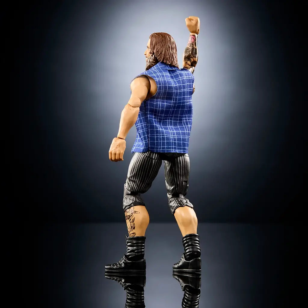 WWE Joe Gacy action figure rear angled view with tan glossy plastic surface, sculpted back muscles and arm tattoos, blue plaid vest, striped pants, and black boots, highlighting articulation against a dark studio background.