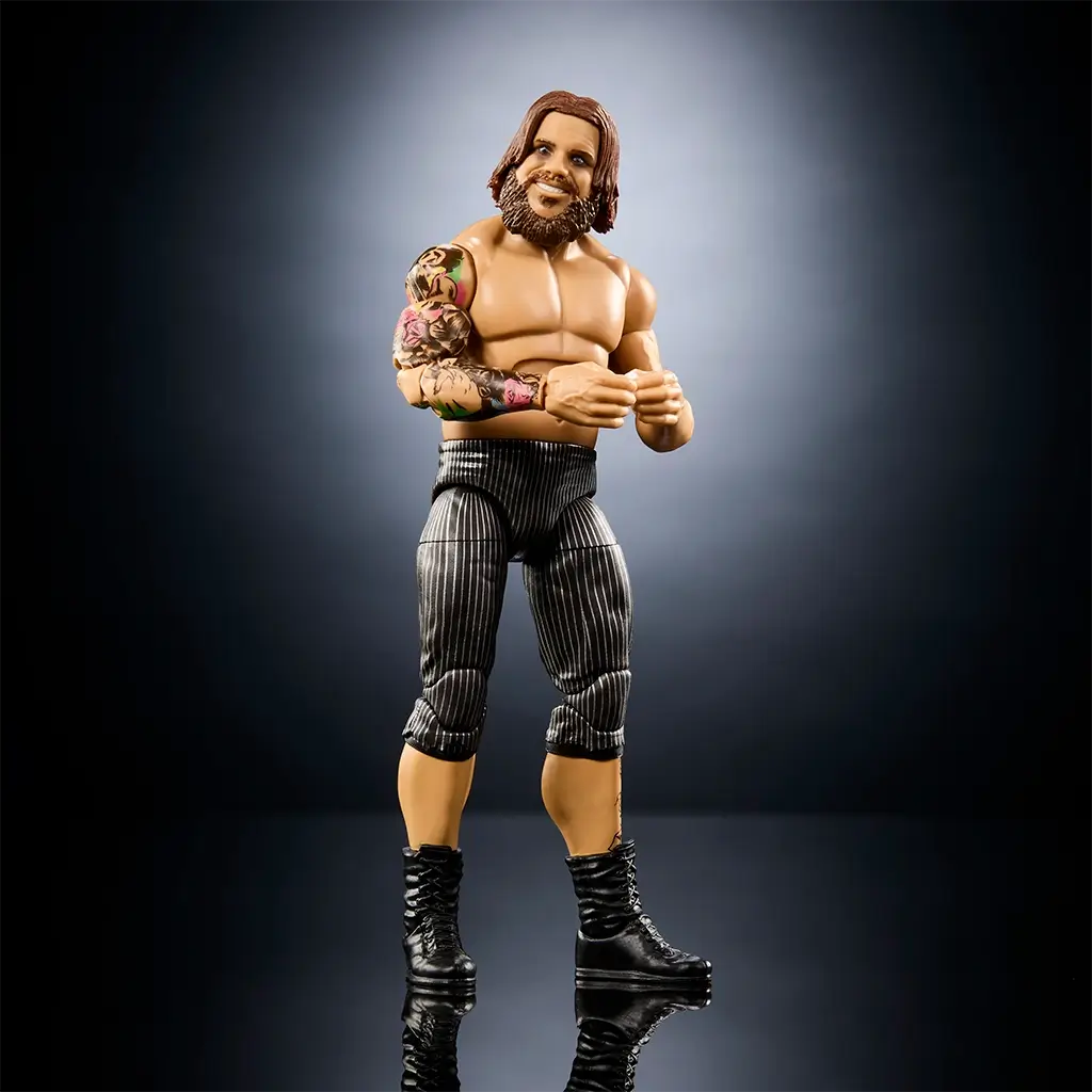 WWE Joe Gacy action figure without mask showing tan glossy plastic skin, detailed bearded head sculpt with long hair, muscular torso, striped pants, and black boots, presented as a fully poseable Elite Collection wrestling collectible.