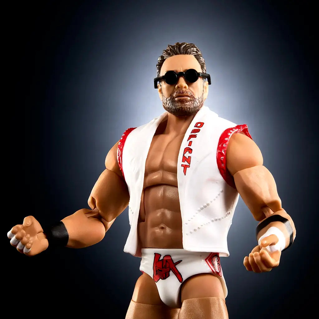 WWE Elite Collection LA Knight wrestling figure close-up showing tan plastic muscular torso, sculpted beard and short brown hair, black sunglasses, white vest with red trim, matching trunks, and confident pose against a dark studio background.