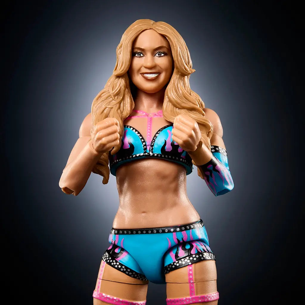 WWE Elite Collection Lola Vice wrestling figure close-up featuring tan and turquoise plastic, detailed facial sculpt, long blonde molded hair, flame-accented ring attire, articulated arms, and confident expression against a dark gradient backdrop.