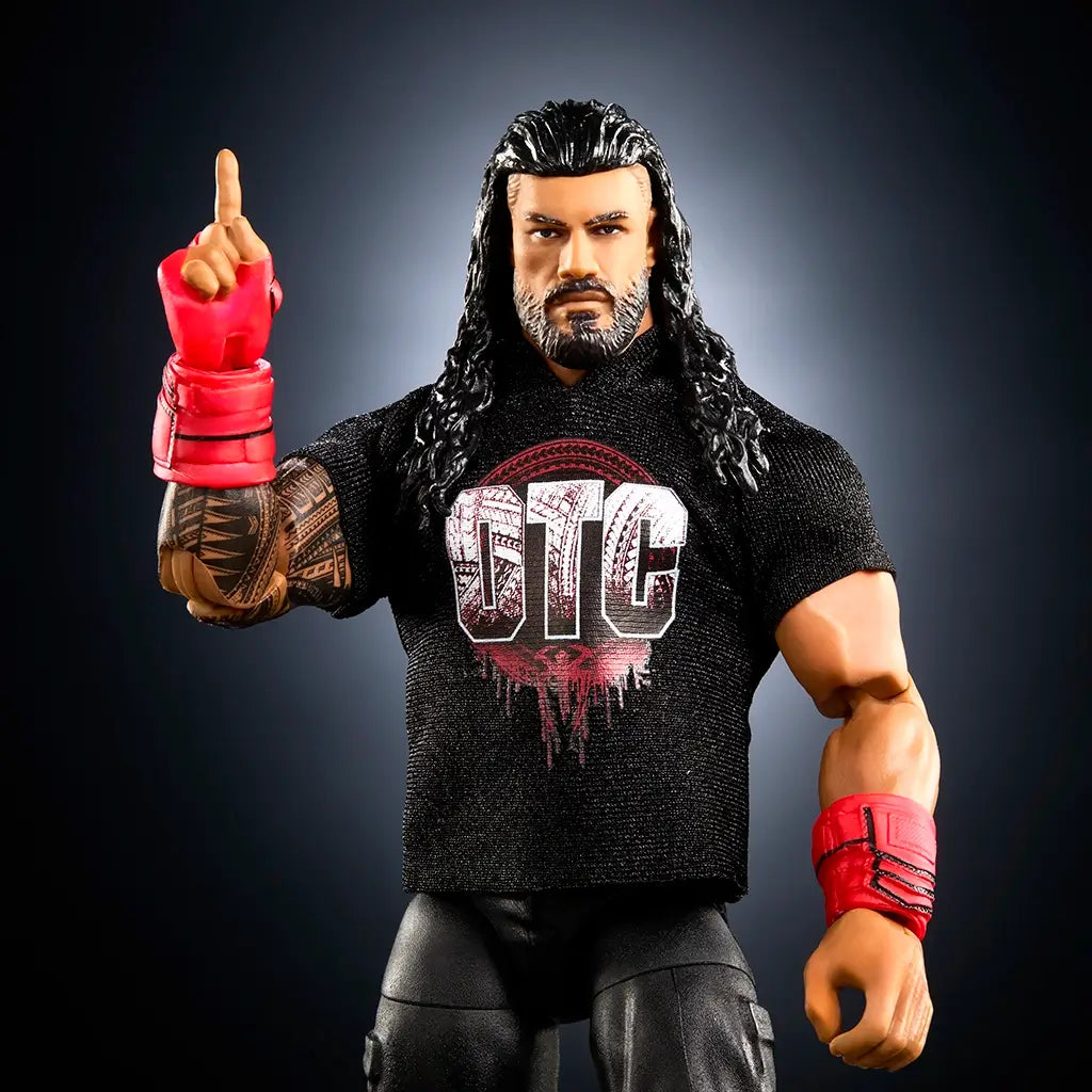 WWE Elite Collection Roman Reigns wrestling figure close-up highlighting realistic facial sculpt, long wet-look black molded hair, sculpted beard, red glove, intricate tattoo detailing, and black OTC logo shirt against a dark gradient background.