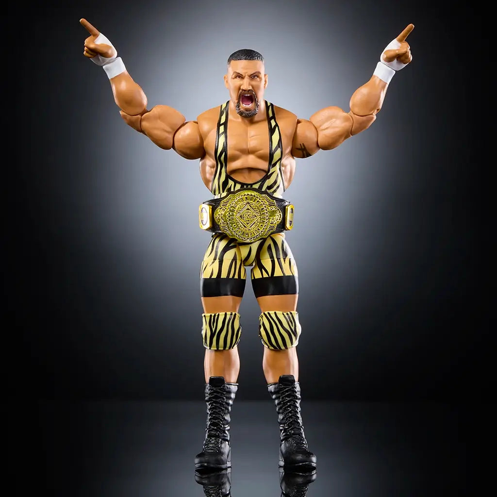 WWE Elite Bron Breakker action figure posed with arms raised, wearing gold championship belt on waist, yellow tiger-striped gear, knee pads, and black boots against a studio-lit dark background.