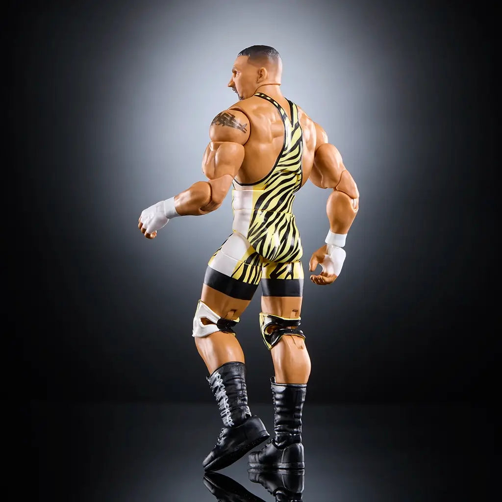 Rear angled view of WWE Elite Bron Breakker action figure highlighting muscular back, tattoo detail, yellow tiger-striped singlet, white wrist tape, and black laced boots against dark background.