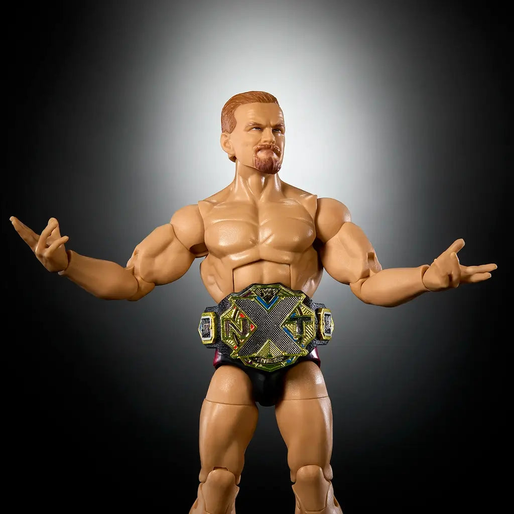 WWE Elite Collection Ilja Dragunov action figure shirtless with sculpted muscles, wearing black trunks and red boots, gold NXT championship belt displayed around waist.