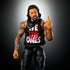 WWE Elite Jimmy Uso figure front view shows lifelike detail with braided hair, tattooed arms, black pants, sleeveless "We The Ones" shirt, and poseable articulation.