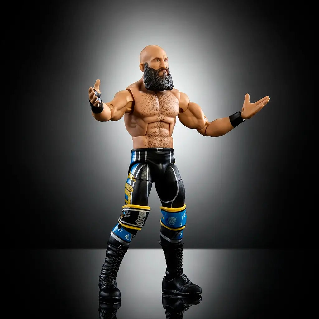 WWE Elite Tommaso Ciampa collectible action figure posed with arms out, shirtless look, detailed tattoos, black pants, and over 25 points of articulation for realistic play.