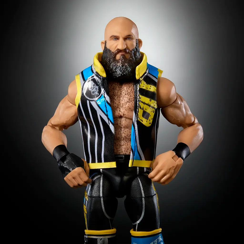 WWE Elite Tommaso Ciampa action figure with black and blue detailed entrance vest, muscular build, and lifelike beard sculpt displayed against a dark gradient background.
