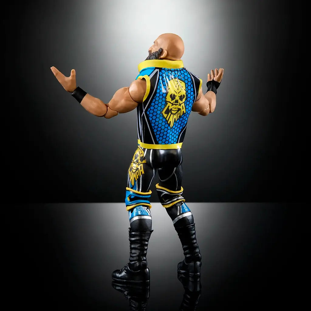 Rear angled view of WWE Elite Tommaso Ciampa action figure displaying detailed vest with yellow skull logo, textured black pants, and articulated arms raised outward.