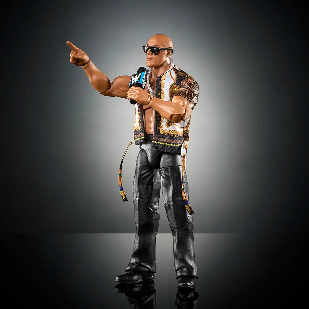 WWE The Rock action figure wearing patterned vest, sunglasses, and holding microphone, posed pointing forward, showcasing articulation and realistic detail.