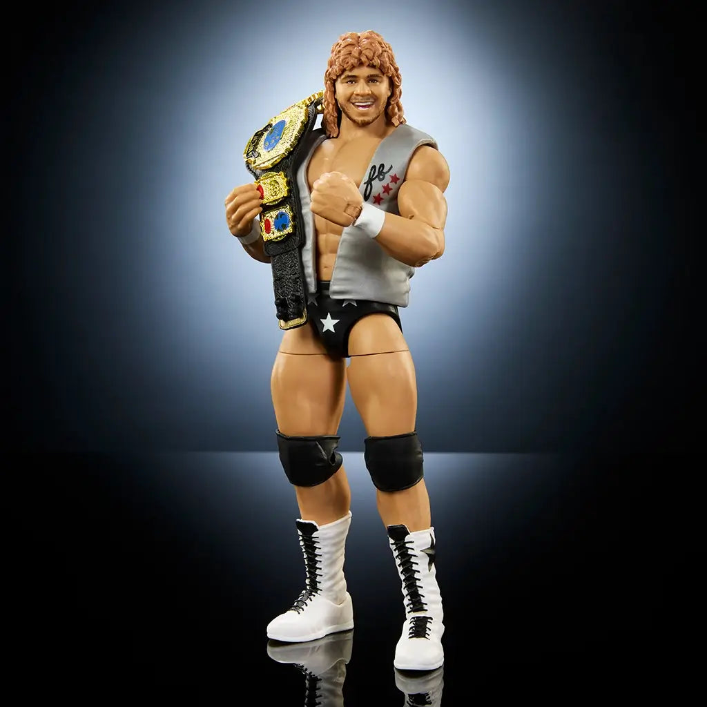 WWE Elite Collection Series 116 Brian Pillman figure posed with championship belt slung over shoulder, wearing silver vest, black trunks with stars, knee pads, and tall lace-up white wrestling boots.