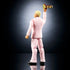 Rear angled view of WWE Cody Rhodes action figure showing fitted pink suit jacket and pants, clean seam sculpting, blond hair detail, raised championship belt accessory, articulated stance, and balanced posture against a dark reflective background.