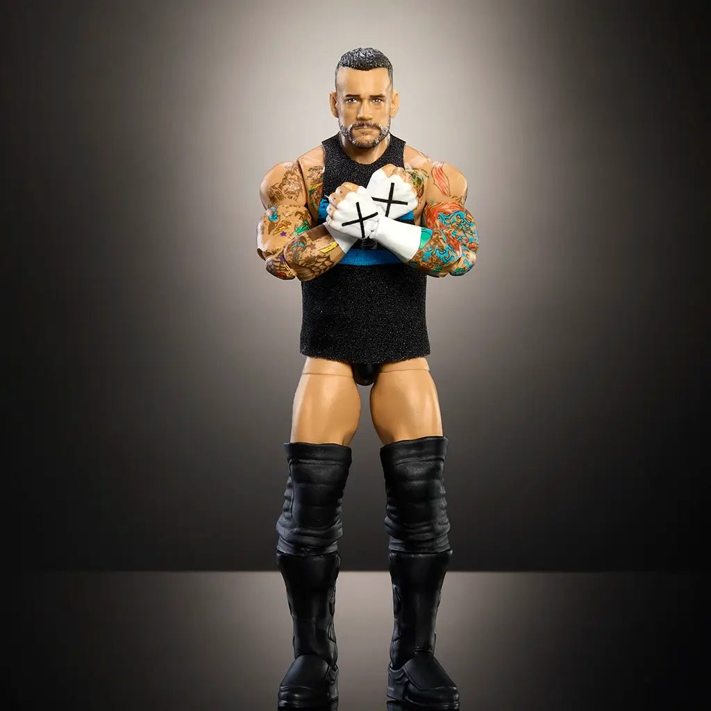 WWE Elite CM Punk action figure in black trunks and vest performing signature cross-armed pose, highly articulated for realistic wrestling display action.