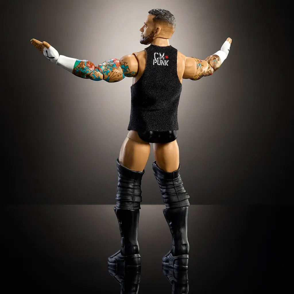 WWE Elite Collection CM Punk action figure in black boots and vest with tattooed arms extended, detailed rear view under dramatic studio lighting for collector display.