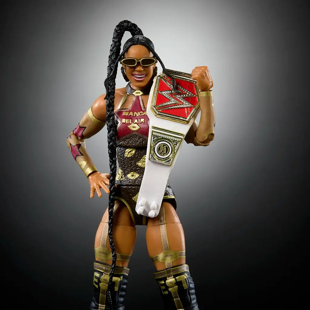 Close-up of Bianca Belair WWE figure smiling in black and gold attire, holding red and white RAW Women’s Championship belt over shoulder, accessorized with sunglasses and long braid.