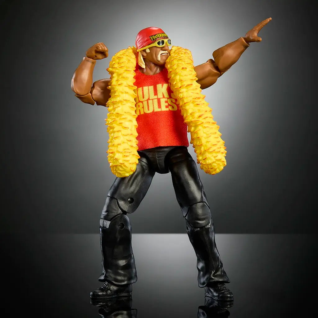 Hulk Hogan action figure posed flexing with red Hulk’s Rules shirt, yellow feather boa, black pants, sunglasses, and articulation for detailed wrestling play or display.
