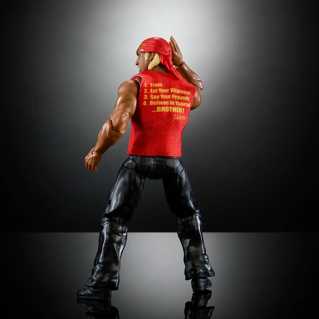 Rear angled view of Hulk Hogan Elite Collection wrestling figure wearing red shirt with motivational text, black pants, red bandana, showing muscular build and hand-to-ear pose.