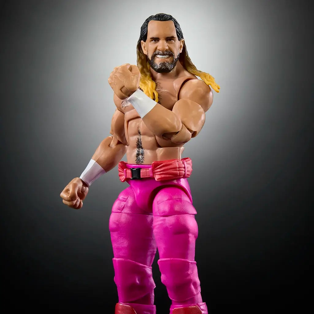 Close-up of WWE Elite Seth Rollins action figure highlighting facial likeness, chest tattoo, muscular arms, pink pants, and expressive pose with clenched fist.