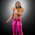 Close-up of WWE Elite Seth Rollins action figure highlighting facial likeness, chest tattoo, muscular arms, pink pants, and expressive pose with clenched fist.