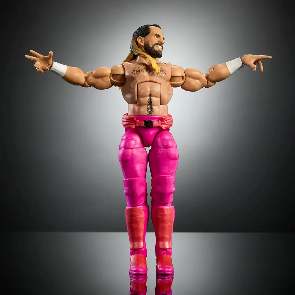 WWE Elite Collection Seth Rollins figure with extended arms pose, showcasing articulation, muscular torso, pink pants, red boots, and black background studio setup.