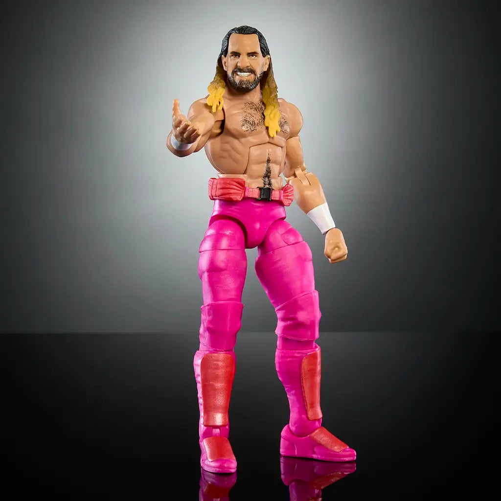 Full front view of WWE Elite Seth Rollins figure in pink wrestling gear, smiling face, chest tattoo, and open stance with hands extended on reflective black surface.