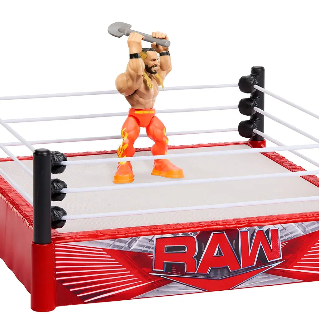 WWE Knuckle Crunchers Seth Rollins figure posed inside RAW rebound ring holding gray toy shovel overhead, showing interactive wrestling play action.