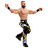 WWE Main Event Series Andrade wrestling figure poseable view featuring tan plastic muscular build, black and yellow ring pants, articulated arms and legs, raised fist pose, black wristbands, and balanced stance on a white studio background.